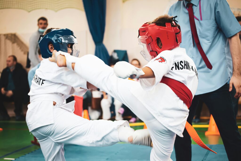 Young boys compete in a martial arts match, showcasing skill and discipline.