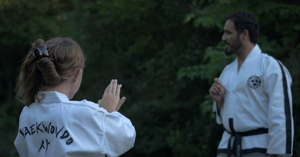 A girl and her instructor practice Taekwondo outdoors in Buenos Aires.