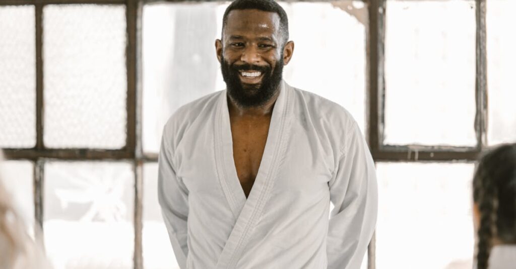 A confident martial arts instructor wearing a black belt in the dojo, exuding positivity.